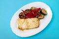 Fish dish - fried cod fish with grilled vegetables in plate Royalty Free Stock Photo