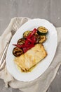 Fish dish - fried cod fish with grilled vegetables in plate Royalty Free Stock Photo