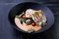 Fish dish: fried cod with spinach and capers in saffron sauce Royalty Free Stock Photo