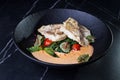 Fish dish: fried cod with spinach and capers in saffron sauce Royalty Free Stock Photo
