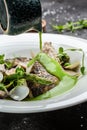 Fish dish - fried fish fillet of zander served with mussels, peas, asparagus and vegetable cream sauce. Restaurant menu Royalty Free Stock Photo