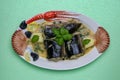 Fish dish top. Close-up of freshly cooked pieces of European eel fish served on a porcelain plate with a creamy dill sauce and Royalty Free Stock Photo