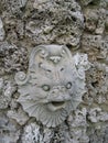 Fish Face Stone Carved Sculpture on Rock Wall Grotto