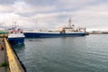 Fish factory ship and a fishing boat in a harbour