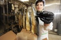 Fish factory worker with smoked fish. Fish industry Royalty Free Stock Photo