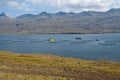 Fish farm in Berufjordur fjord in eastern Iceland from Ring Road on sunny day.