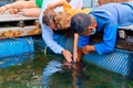 Fish farm excursion. Man feeding stingray close up