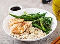 Fish fillet served with rice, soy sauce and green beans in white plate. Royalty Free Stock Photo