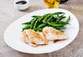 Fish fillet served with soy sauce and green beans in white plate. Royalty Free Stock Photo