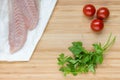 Fish fillets with cherry tomatoes and fresh parsley leaves