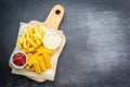 Fish finger and french fries or chips with tomato ketchup and mayonnaise sauce