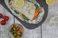 Fish in foil on a stone baked with lemon and vegetables Royalty Free Stock Photo