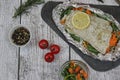 Fish in foil on a stone baked with lemon and vegetables Royalty Free Stock Photo