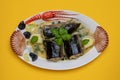 Fish food. Close-up of freshly cooked pieces of European eel fish served on a porcelain plate with a creamy dill sauce and Royalty Free Stock Photo