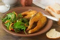 Fish fried in corn flour, served with salad, bread and wine. Royalty Free Stock Photo