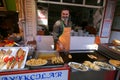 Man frying fish at food stall