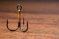 Fish Hook with 3 hooks on a wooden background Royalty Free Stock Photo