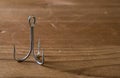 Fish Hook on a wooden surface Royalty Free Stock Photo