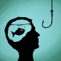 Fish in the human head. Man looking on a fishing hook. Lies, dec