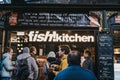 Fish Kitchen stall in Borough Market, London, UK people queue in front, selective focus Royalty Free Stock Photo
