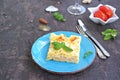 Fish lasagna with salmon and cheese on a blue plate on a dark brown concrete background. Fish and seafood recipes Royalty Free Stock Photo