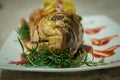 Fish with lemon wedges and a green rosemary. Shallow depth of field.