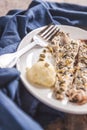 Fish mackerel baked with herbs, mashed potatoes, pesto sauce ser Royalty Free Stock Photo