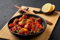 Fish Manchurian dry looks like Schezwan Fish in black bowl at dark slate background