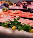 Fish market showcase with tuna and salmon meat and artificial lemon branches and fruit