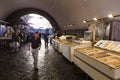 Local people and tourists buying fresh fish on a fish market