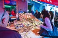 Local people and tourists buying fresh fish on a fish market