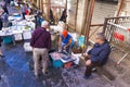 Local people and tourists buying fresh fish on a fish market