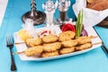 Fish meat shish kebab with greens, tomatoes, cheese and red onion with cream sauce Royalty Free Stock Photo