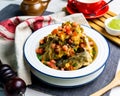 Fish Nachos topping with tomato chops served in bowl isolated on wooden bard side view of japanese seafood on table