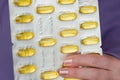 Fish oil capsules in blisters set in hands .Dietary supplements in womens nutrition. Fish oil for womens health.omega