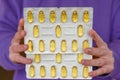 Fish oil capsules in blisters set in hands .Dietary supplements in womens nutrition. Fish oil for womens health.omega