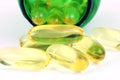 Fish oil capsules with green pill bottle Royalty Free Stock Photo