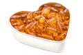 Fish oil capsules in heart shape bowl Royalty Free Stock Photo