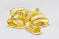 Fish oil capsules omega 3 on light background. Transparent yellow capsules of fish oil Royalty Free Stock Photo