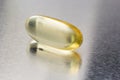 Fish oil capsules omega 3 on light background. Transparent yellow capsules of fish oil Royalty Free Stock Photo