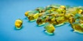 Fish oil capsules with omega 3 and vitamin D, isolated on blue background. Yellow vitamin pills. Medicine and healthy Royalty Free Stock Photo