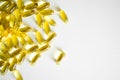 Fish oil capsules, omega 3, on white surface. Oil filled capsules, softgel of food supplements. Royalty Free Stock Photo