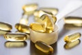 Fish oil capsules on wooden background and texture, vitamin D supplement