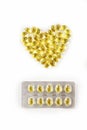 Fish oil from cod liver in capsules for children and adults in the form of a heart with a block of tablets on a white background, Royalty Free Stock Photo