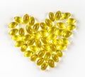 Fish oil from cod liver in capsules for children and adults in the form of a heart on a white background, prevention Royalty Free Stock Photo