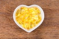 fish oil in heart shape bowl Royalty Free Stock Photo