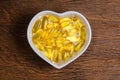fish oil in heart shape bowl Royalty Free Stock Photo