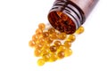 Fish oil or krill oil capsules in a dark bottle, vitamin D omega-3, top view. Isolate on white