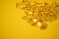 Fish oil omega 3 gel capsules isolated on yellow background. Healthcare concept Royalty Free Stock Photo