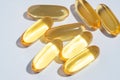 Fish Oil Omega 3 on white background, vitamin D yellow supplement gel capsules, macro shot. Royalty Free Stock Photo